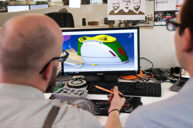 Product designers looking at CAD file on a screen