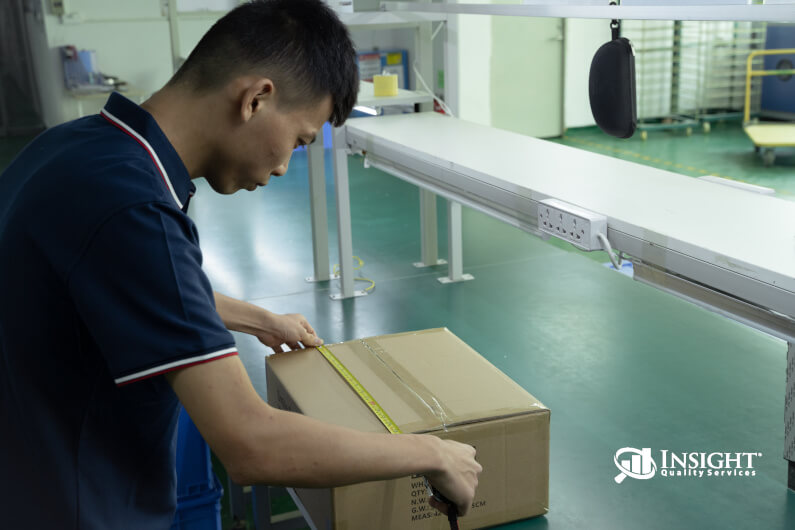 Inspector measuring carton