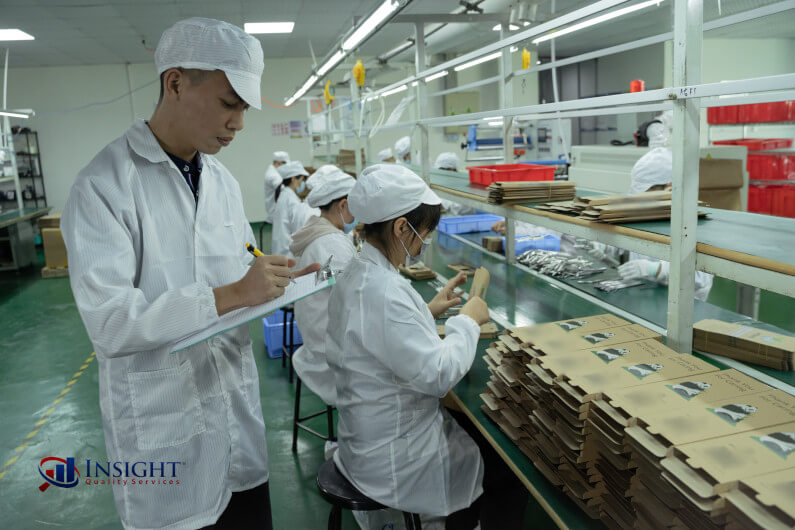 Auditor examining production line