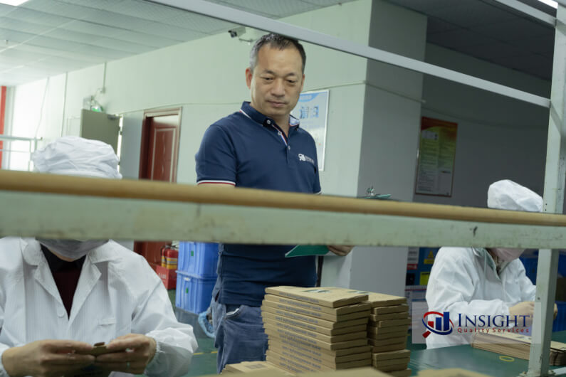 Auditor observing workers