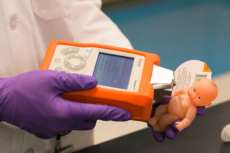 Person scanning a toy doll to determine phthalate levels