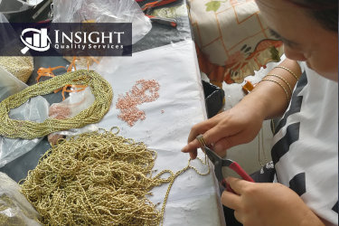 Factory worker connecting the chains with jump rings, so that it is easily hang the chains to shelves for plating