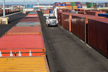 CBP truck driving by containers at port