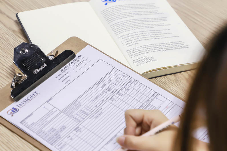 Inspector writing on clipboard