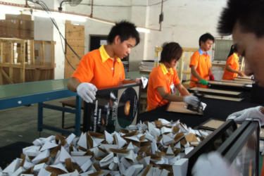 Factory workers in a factory that produces picture frames
