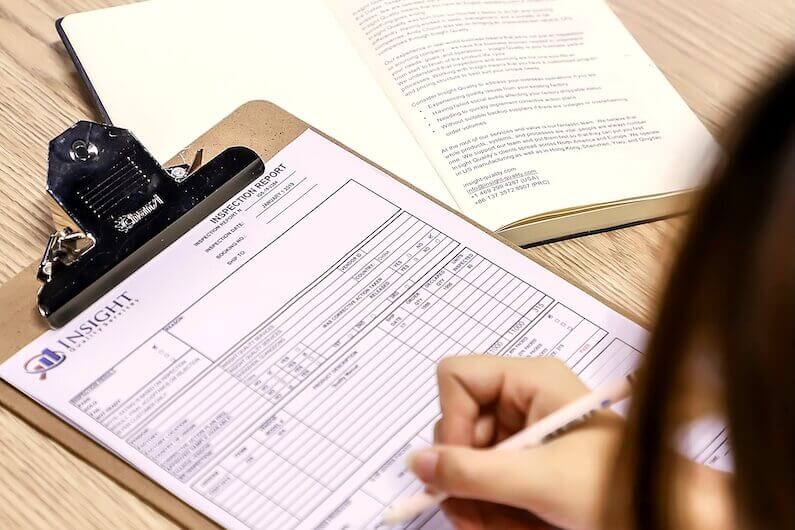 Inspector writing inspection report