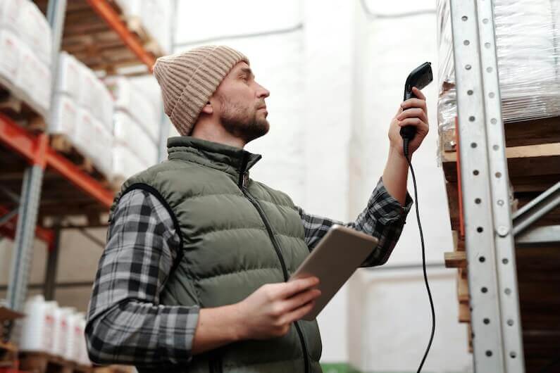 Man scanning a barcode in a warehouse